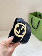 Navy textured belt with gold-toned circular logo buckle