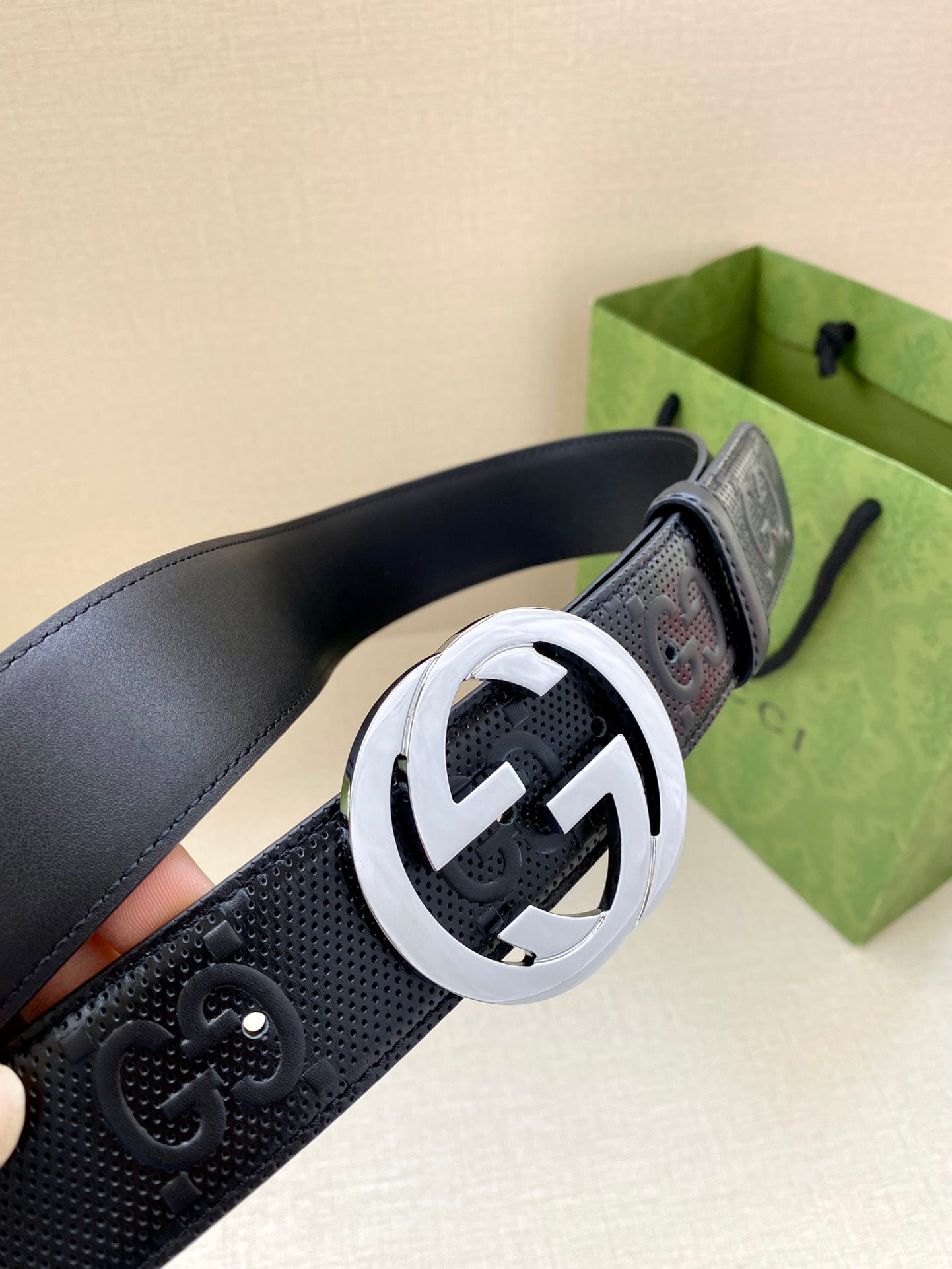 Navy belt with textured strap and silver-toned circular GG buckle