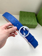 Gucci belt with blue leather and silver interlocking GG buckle, textured finish.