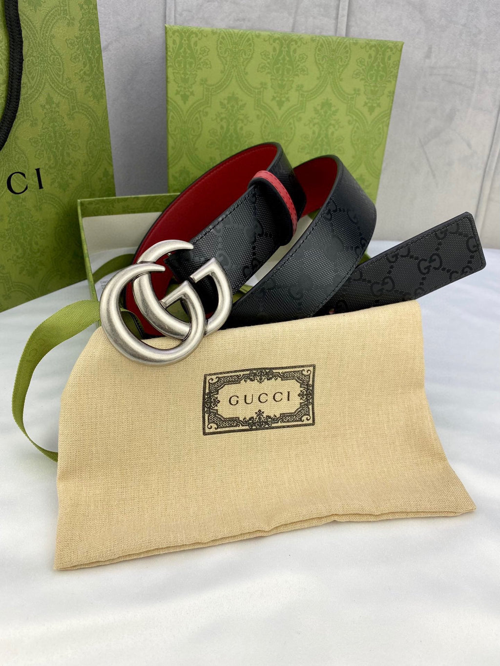 Gucci belt with black monogram leather and large silver-tone double G buckle, red lining