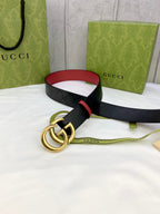 Gucci belt with black logo leather, red lining, and gold-tone interlocking double G buckle