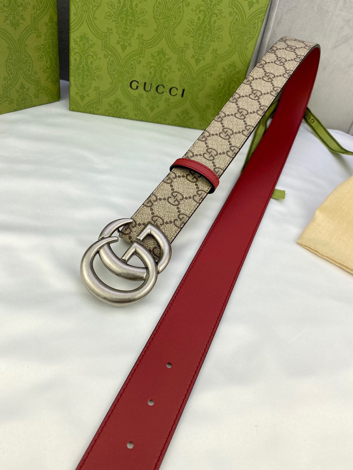 Gucci belt with red leather strap, GG monogram canvas center, silver double-G buckle