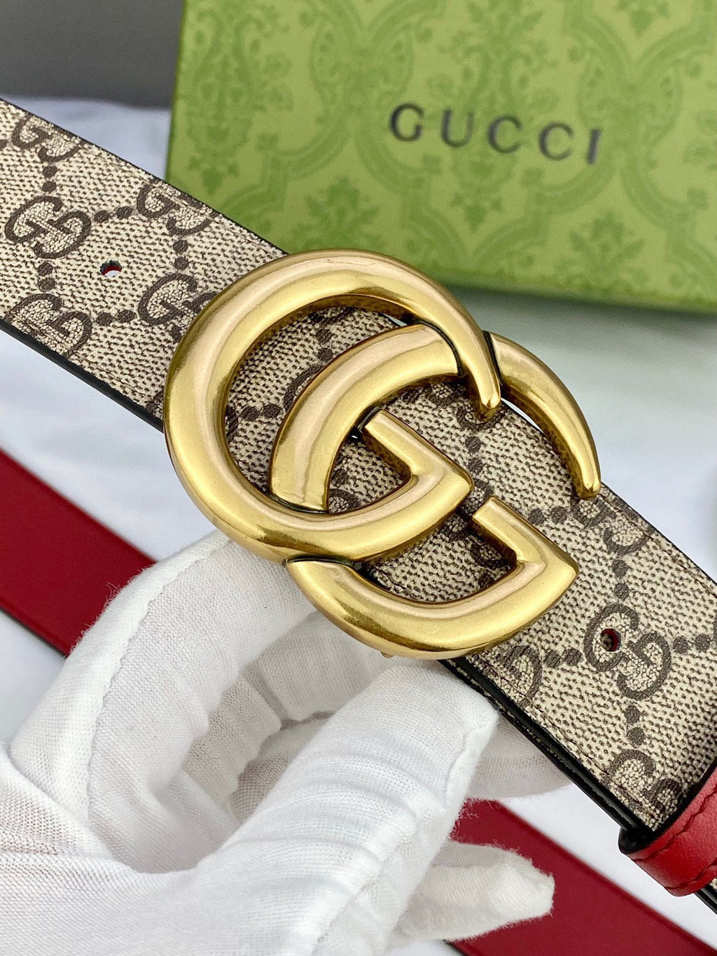 Gucci belt close-up: GG canvas with red edge and gold-toned double-G buckle