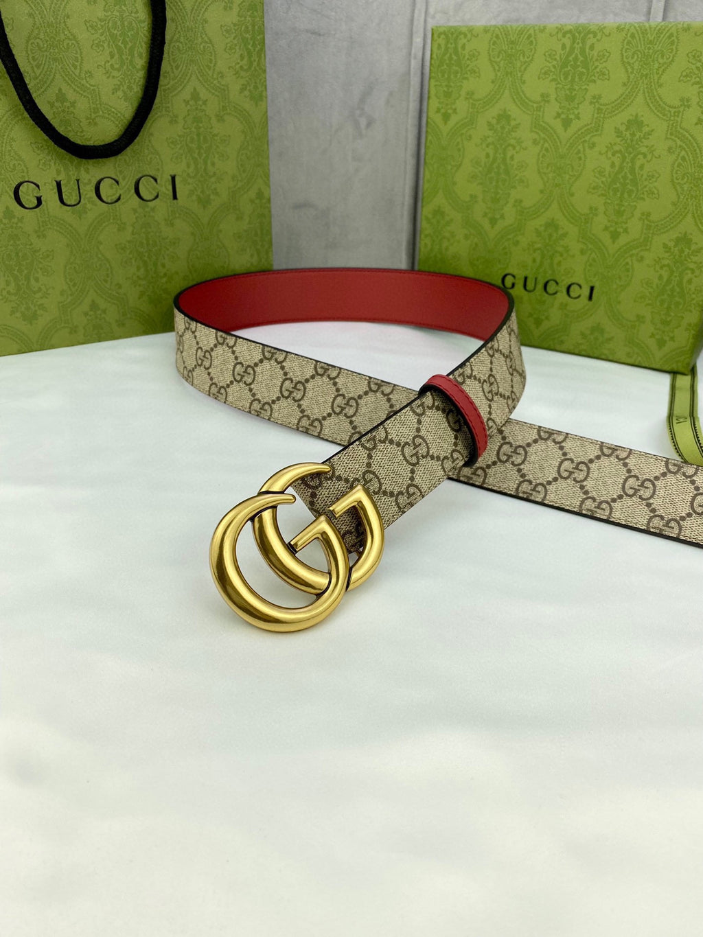 Gucci belt with GG monogram strap, red leather trim, gold-toned double-G buckle