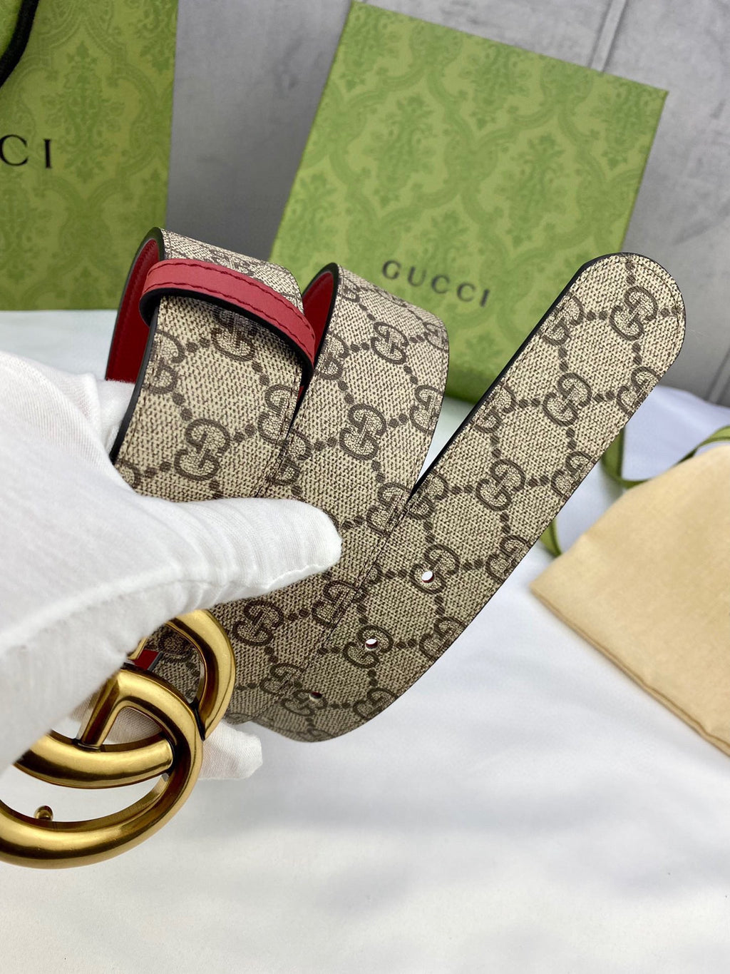 Gucci belt with GG monogram canvas, red edge, gold-toned double-G buckle and rings