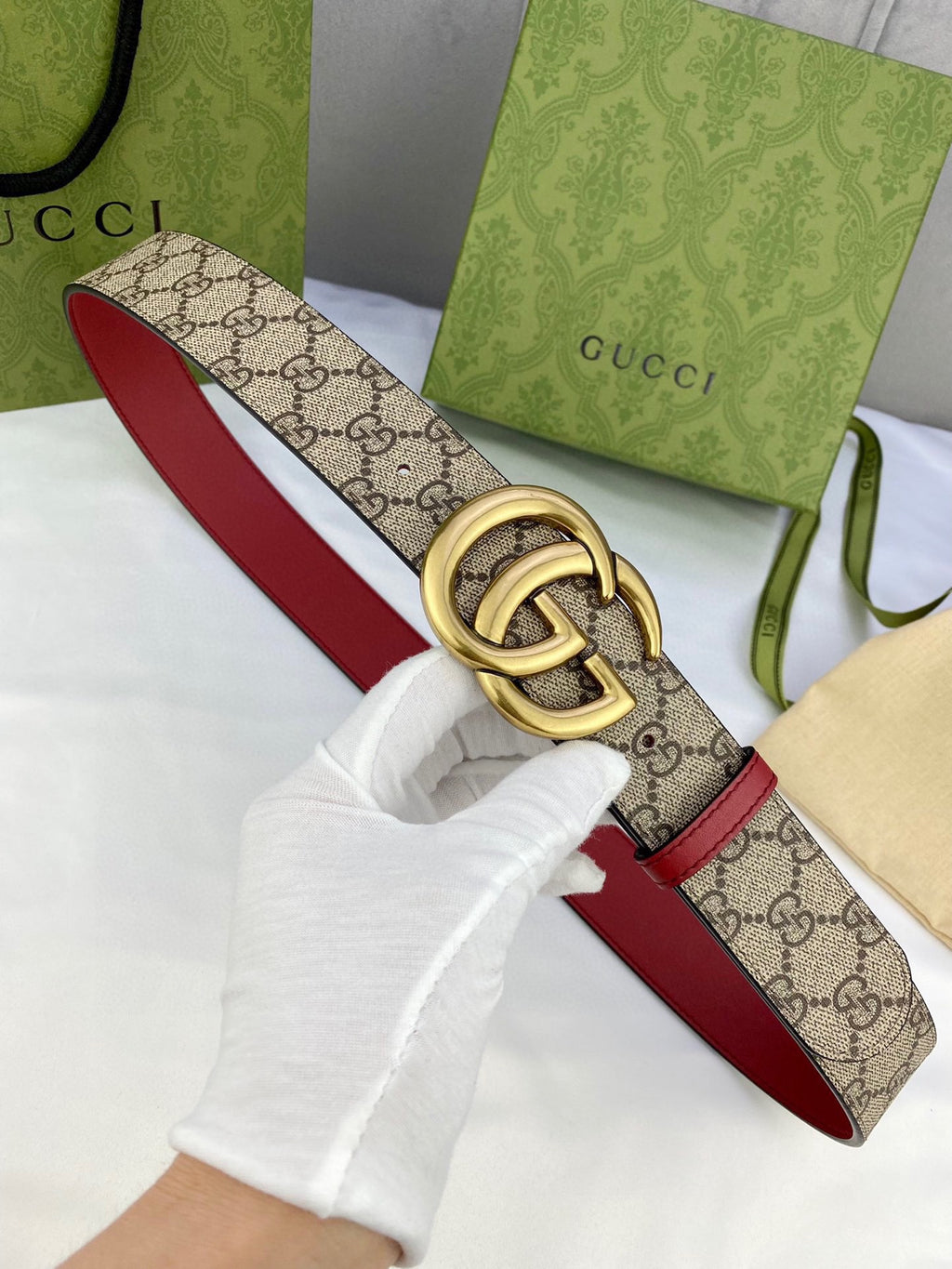 Gucci belt with GG monogram canvas and red leather edges, gold-toned double-G buckle
