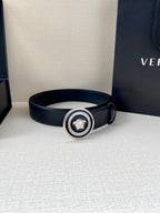 Dark blue Versace belt with round Medusa buckle, displayed beside shopping bag