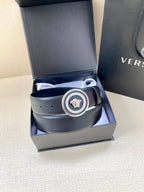Dark blue Versace belt with round Medusa buckle, shown inside open box