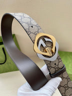GG monogram belt with oval gold buckle on dark brown leather backing, close-up