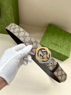 Gucci GG monogram belt with gold-toned buckle and dark brown leather strap