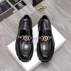 Black leather loafers with gold logo buckle, squared toe, chunky lug sole.