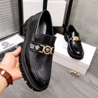 Black leather loafer with gold buckle detail and stitched moc toe, chunky sole.