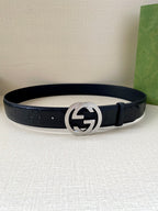 Gucci belt in dark navy with silver interlocking G buckle, flat on surface