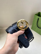 Navy leather belt with embossed monogram texture and gold-toned interlocking G buckle