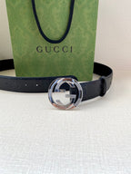 Navy leather belt with embossed logo strap and large silver-toned buckle