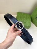 Navy leather Gucci belt with embossed logo pattern and silver-toned buckle
