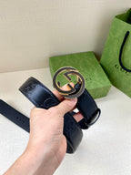 Dark navy belt with Interlocking G buckle and embossed pattern on strap