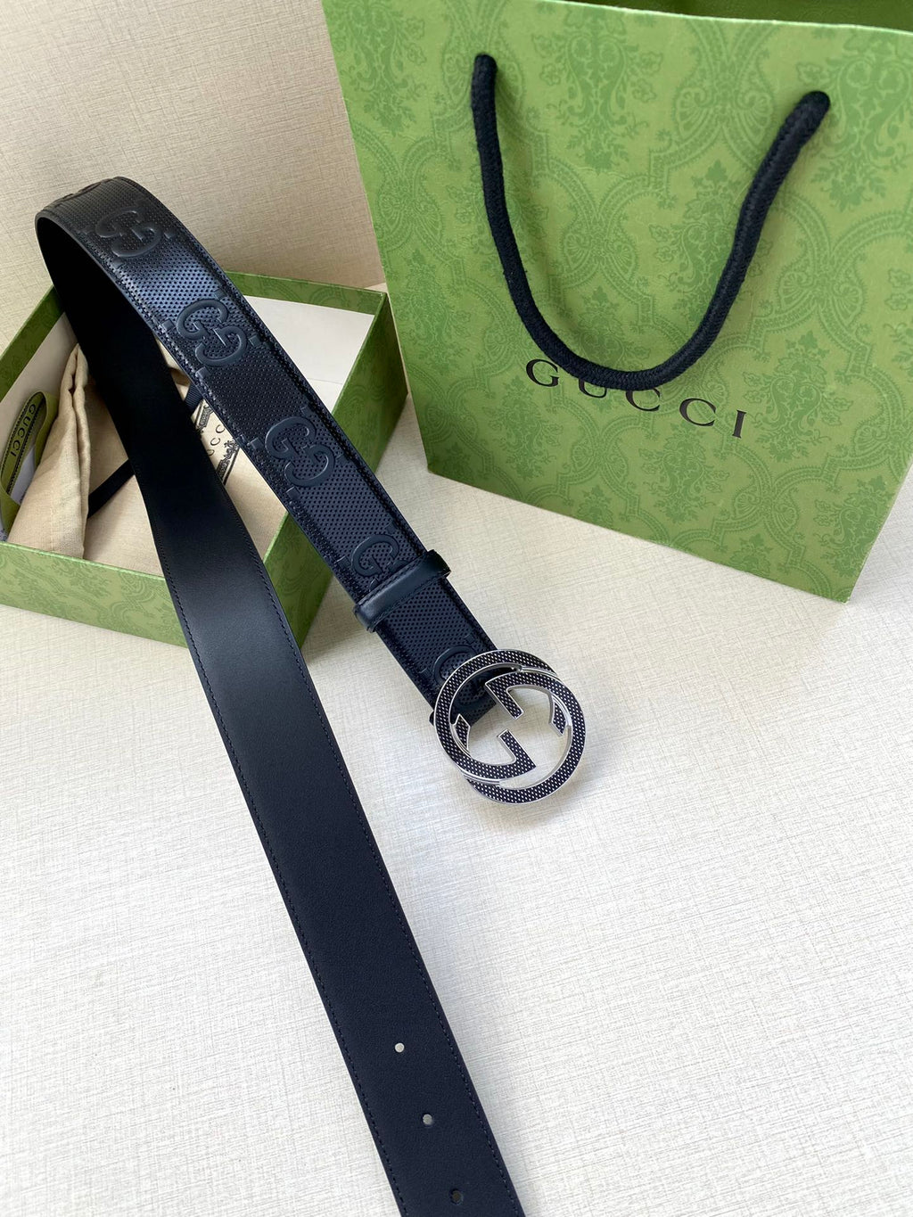 Dark navy belt with Interlocking G buckle and perforated logo embossing