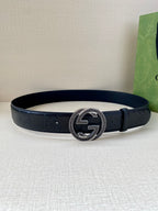 Dark navy belt with round Interlocking G buckle and embossed logo trim