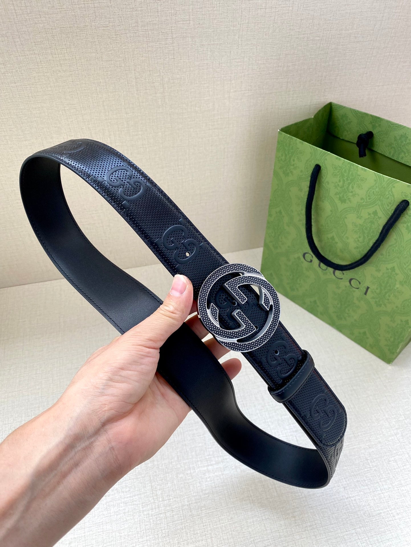 Dark navy belt with Interlocking G buckle on embossed leather strap