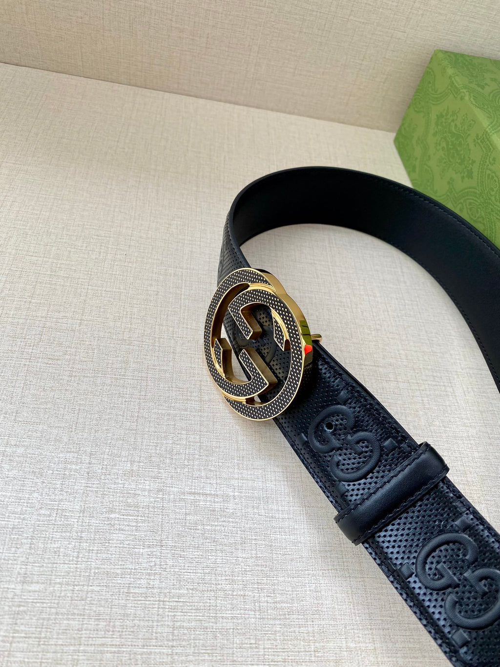 Dark navy belt with round Interlocking G buckle on embossed leather strap