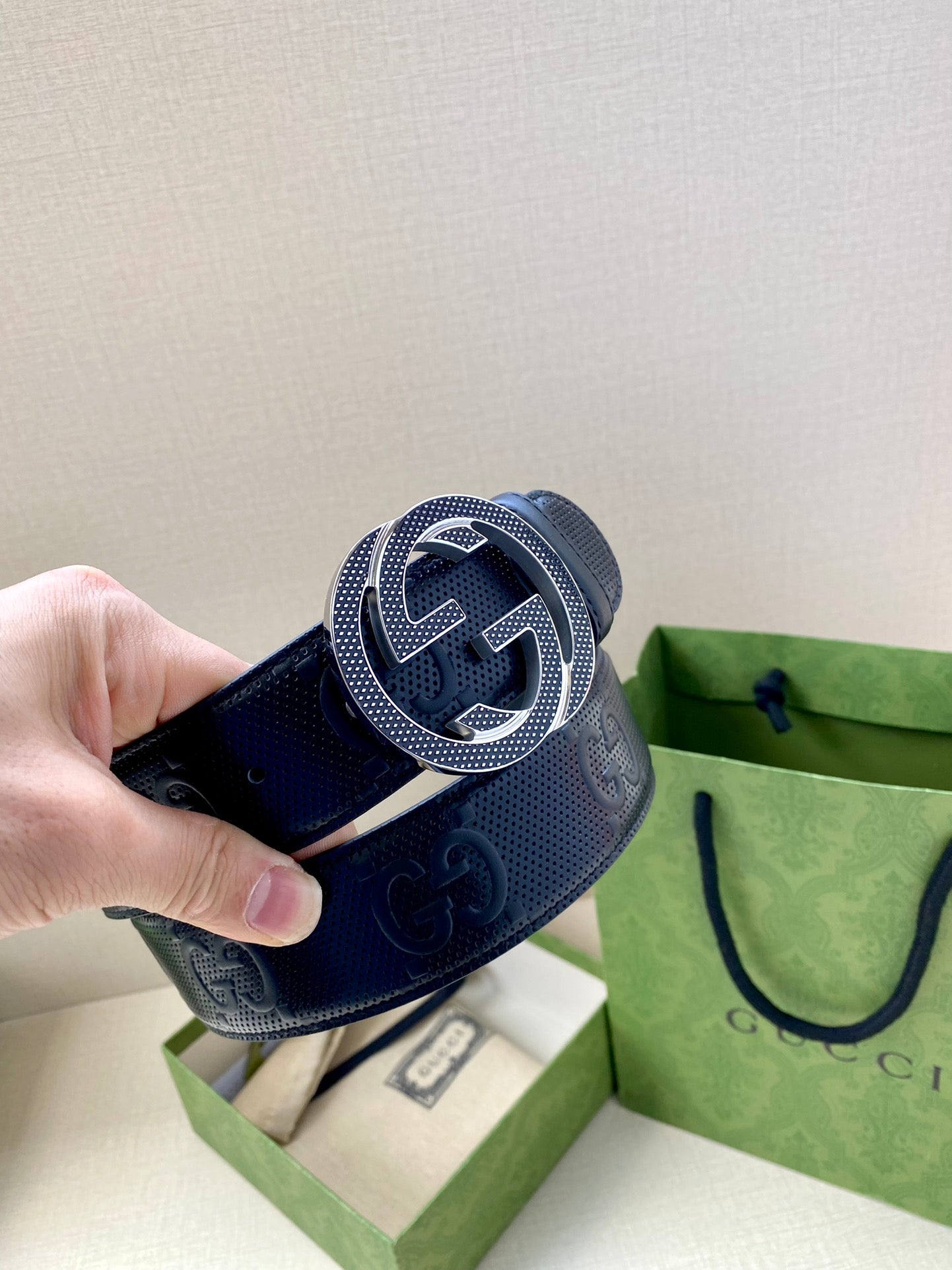 Dark navy belt with Interlocking G buckle on embossed leather strap