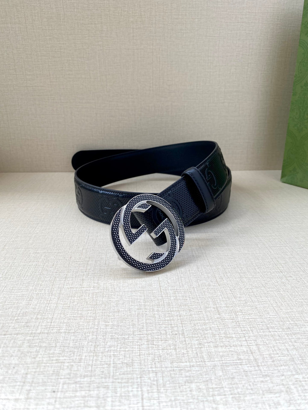 Dark navy belt with round Interlocking G buckle and embossed strap texture