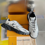 Unisex white-and-gray Louis Vuitton sneakers with black rubber sole, lace-up style