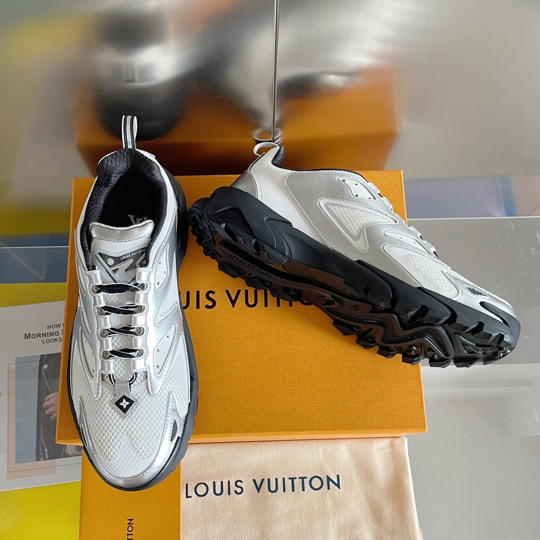 Unisex white Louis Vuitton sneakers with black tread sole, side view