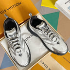 Pair of white Louis Vuitton sneakers with black soles, lace-up closure and logo accents