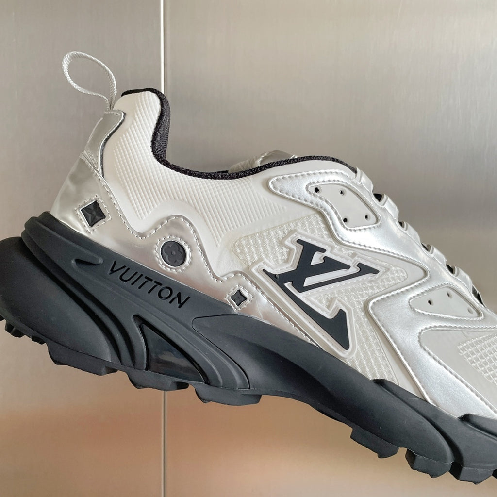 Close-up of white Louis Vuitton sneaker with black sole and visible logo on side