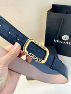 Designer belt with dark blue embossed leather and ornate gold buckle clasp