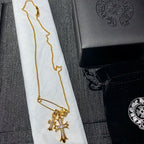 Gold cross pendant necklace with long chain and clasp detail