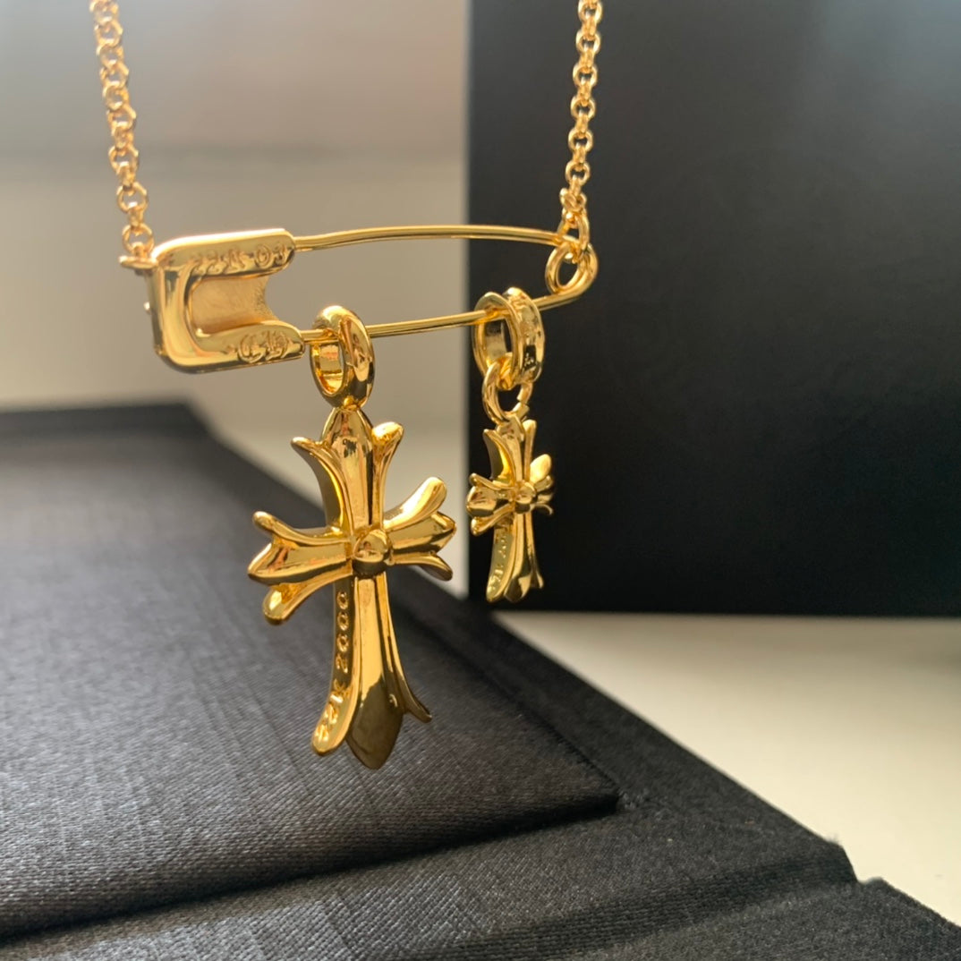 Gold cross pendant necklace with linked chain and small cross charm drops
