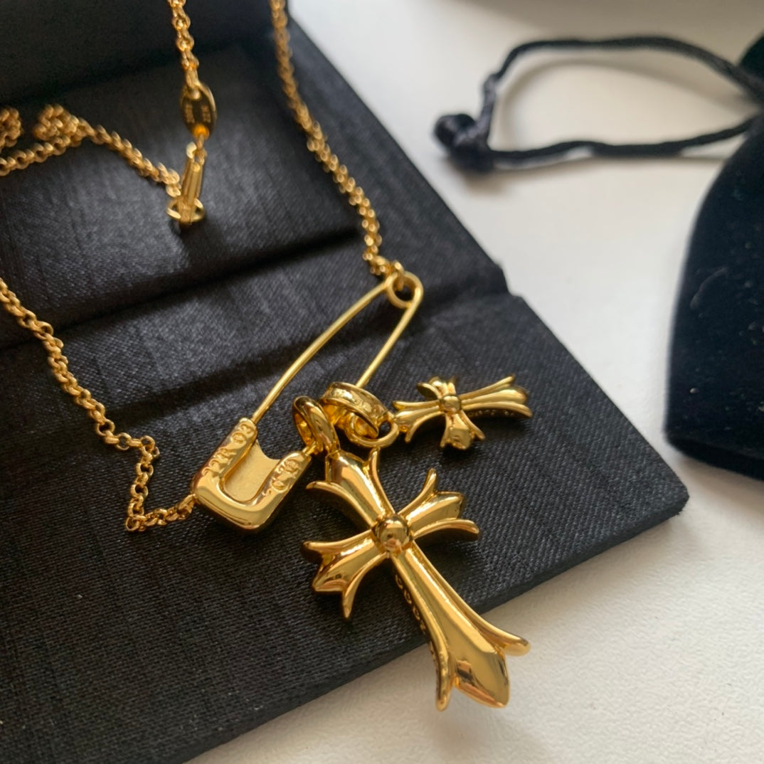 Gold cross pendant necklace with curved clasp and cross-shaped charm