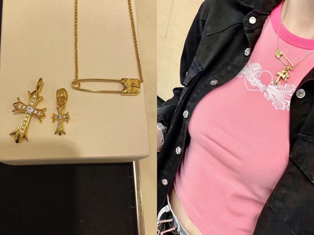 Gold cross pendant necklace with pink gemstone accents worn with a pink shirt
