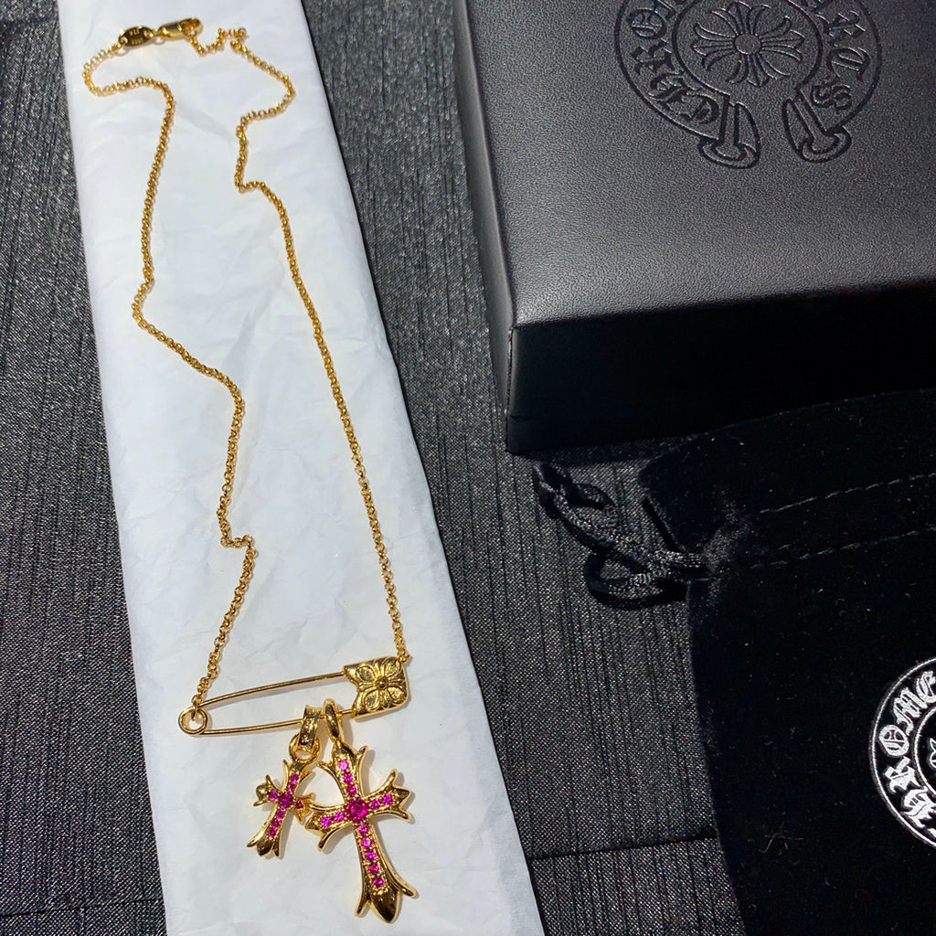Gold chain necklace with pink cross pendant and bar clasp