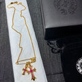 Gold chain necklace with pink cross pendant and bar clasp