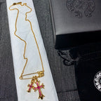Gold chain necklace with pink cross pendant and bar clasp