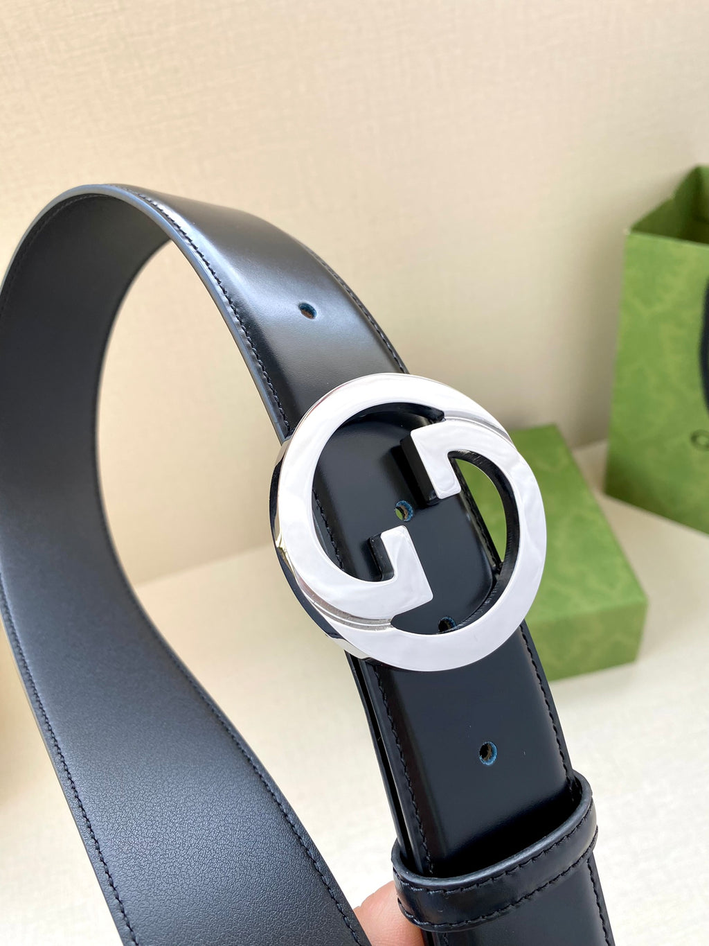 Gucci belt, dark blue leather belt with silver-tone G buckle close-up