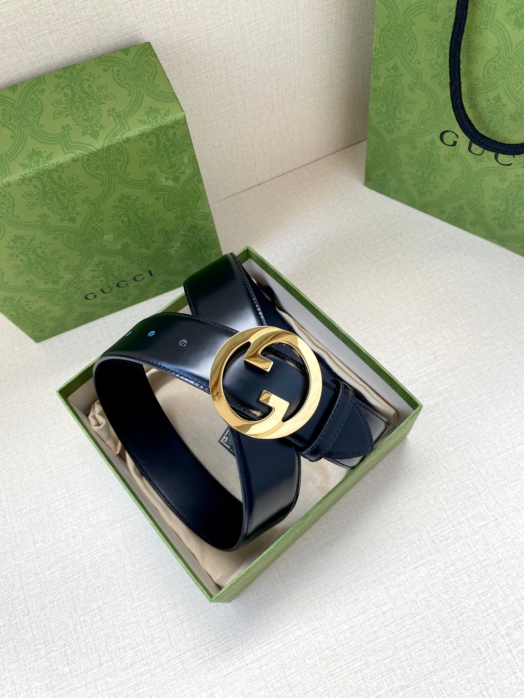 Gucci belt, dark blue leather strap with gold-tone G buckle in open box