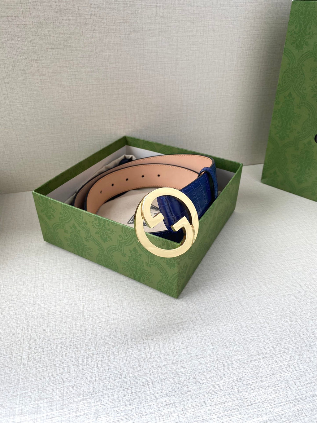 Blue croc-embossed Gucci belt with gold-tone GG buckle