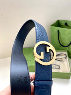 Gucci belt detail: dark blue strap with G buckle and gold center