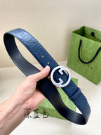 Gucci belt strap view: dark blue embossed leather with gold-and-white G buckle