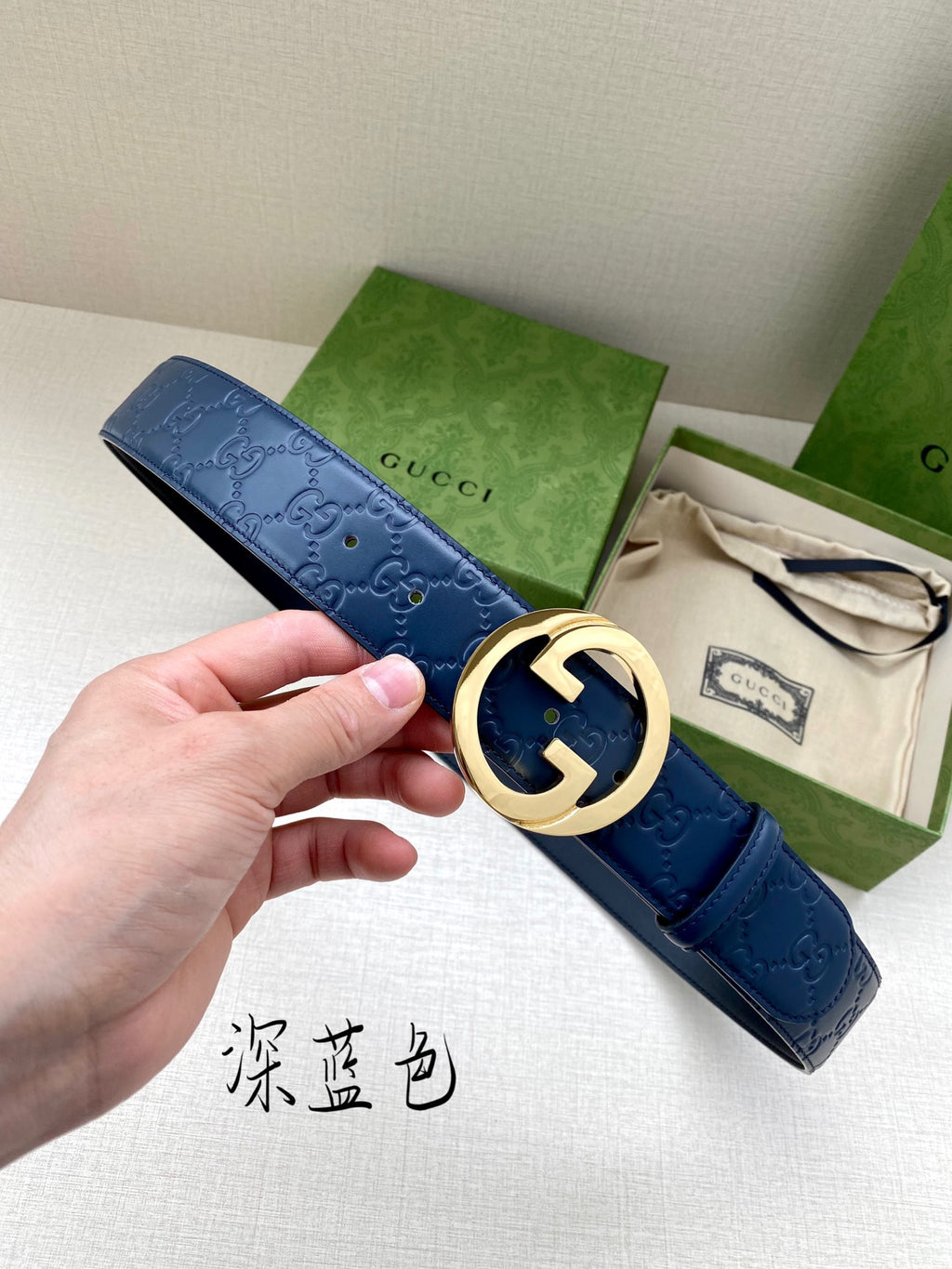 Gucci belt in dark blue with embossed pattern and gold-tone G buckle
