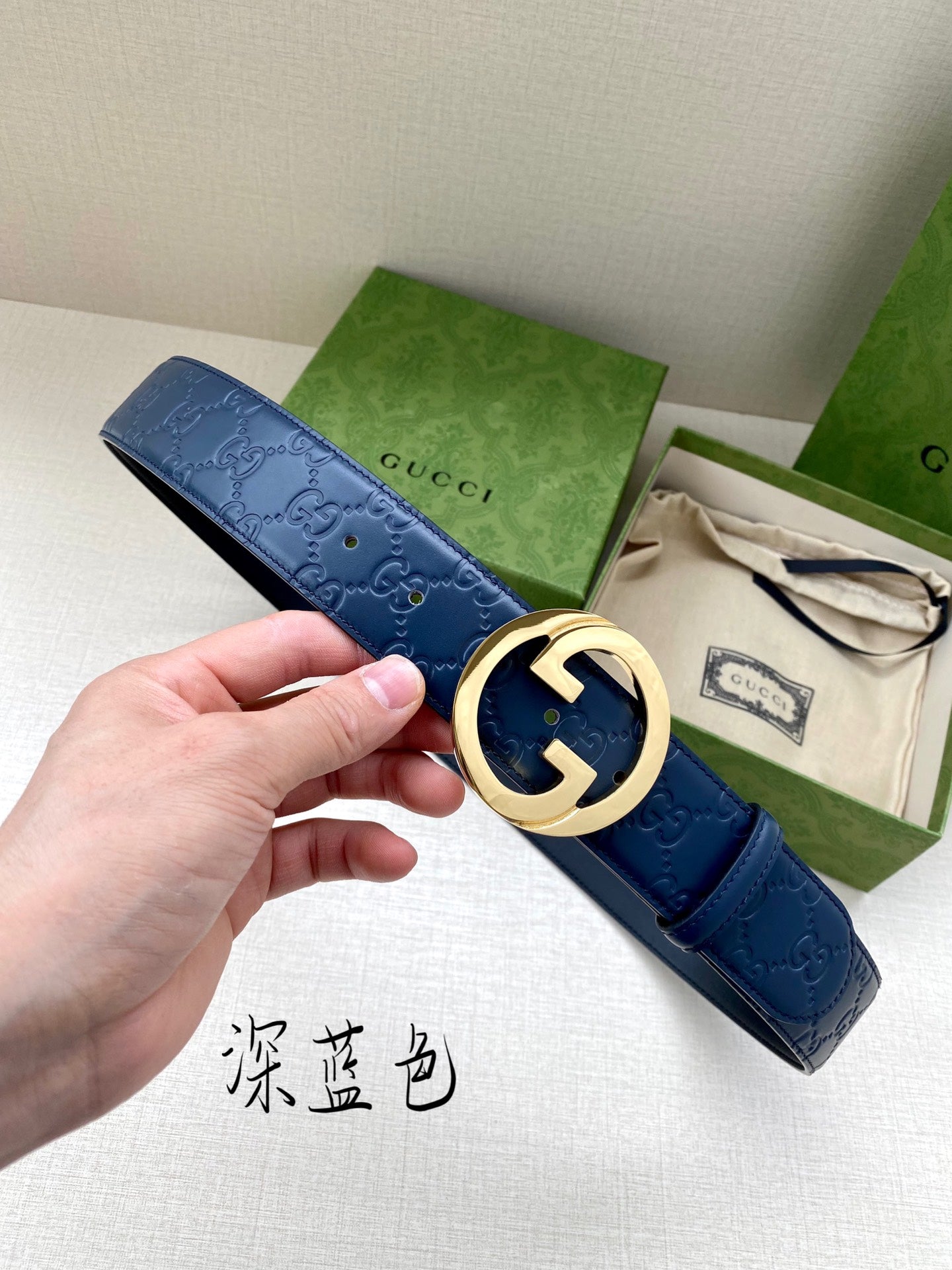 Gucci belt in dark blue with embossed pattern and gold-tone G buckle