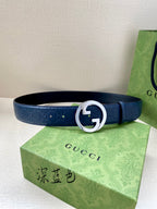 Gucci belt: dark blue embossed strap with silver and gold G buckle