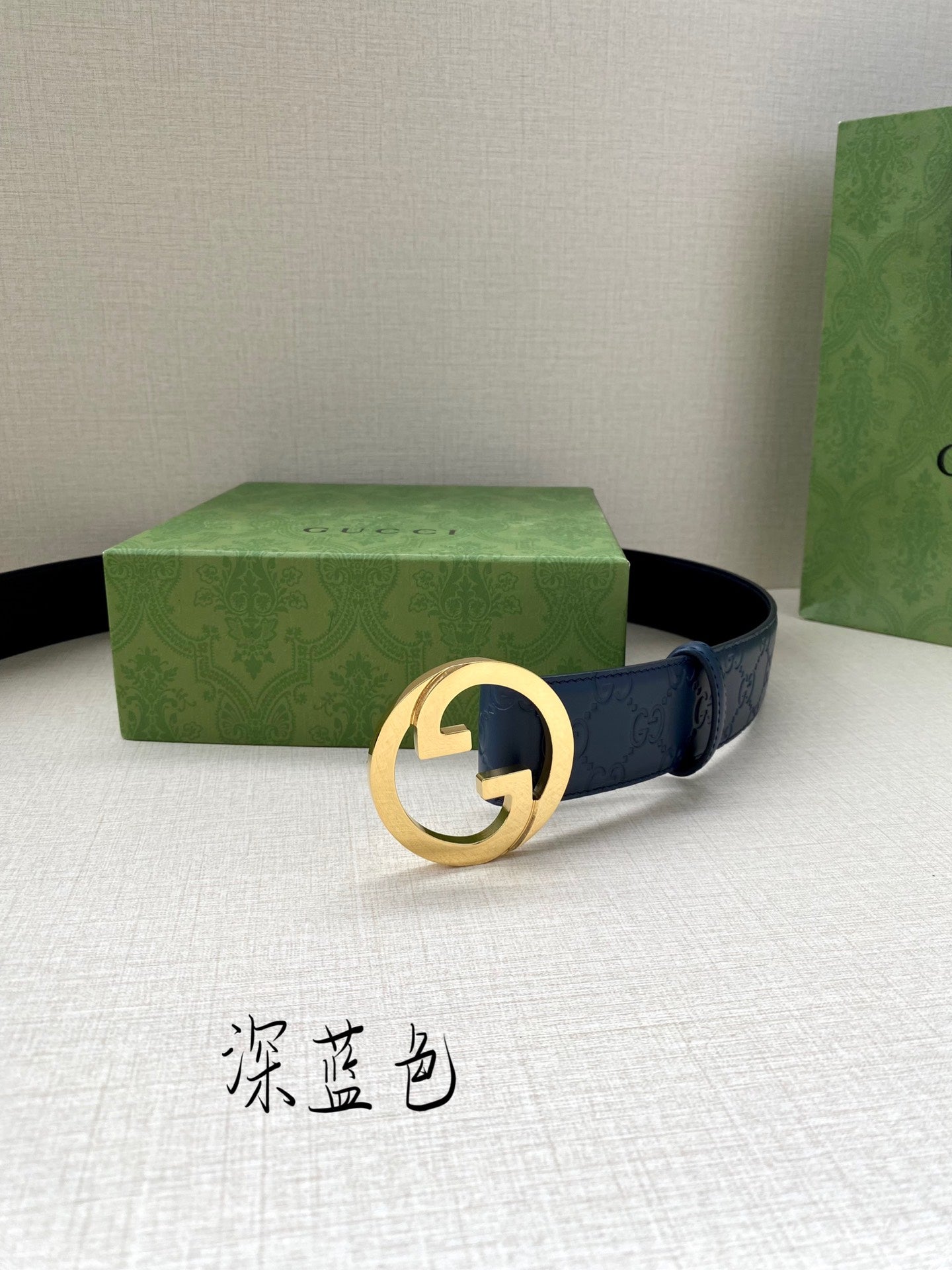 Gucci belt dark blue strap with round G buckle, shown laid flat