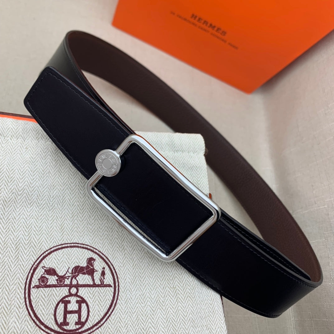 Leather belt with rectangular silver buckle and embossed leather strap, dark blue.