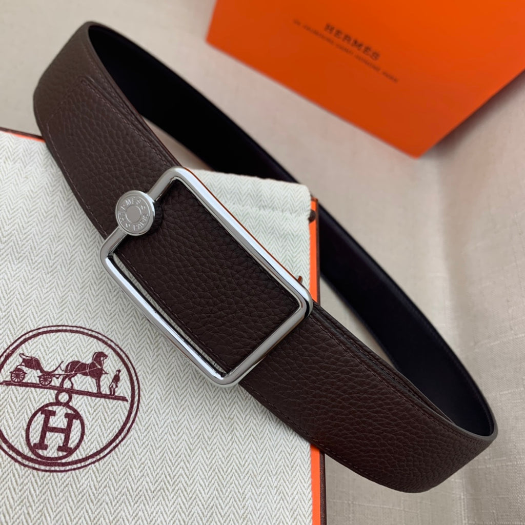 Leather belt with rectangular silver buckle and embossed leather strap, dark brown.